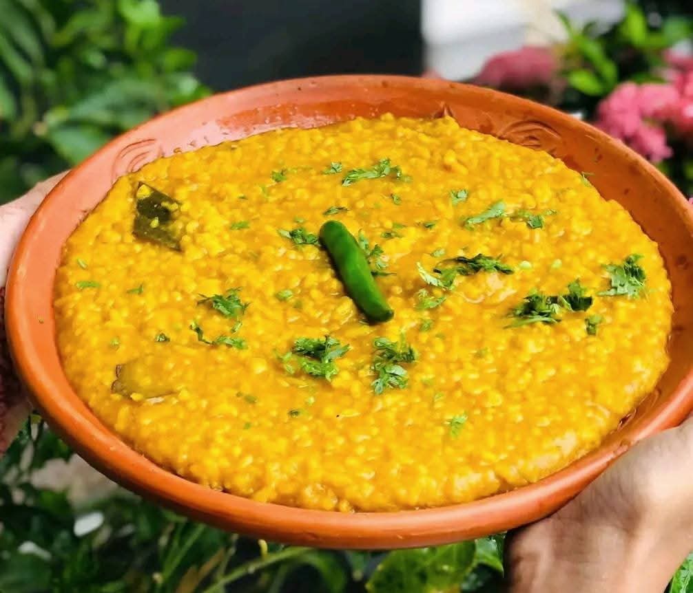 A traditional meal spread with rice, curry, and salad